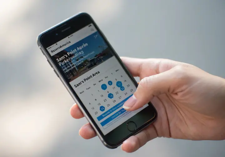 Planning a Sam's Point visit: Smartphone screen showing the mandatory parking reservation booking system on ReserveAmerica.
