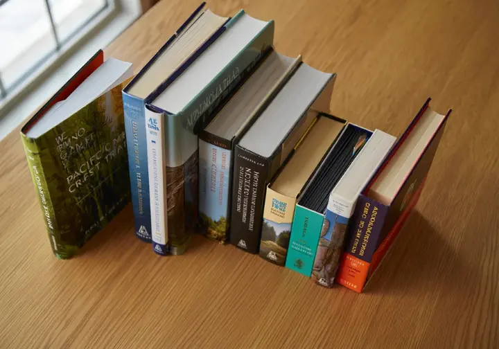 Top book recommendations for thru-hiking featuring highly-rated memoirs and guides for the AT, PCT, and CDT.