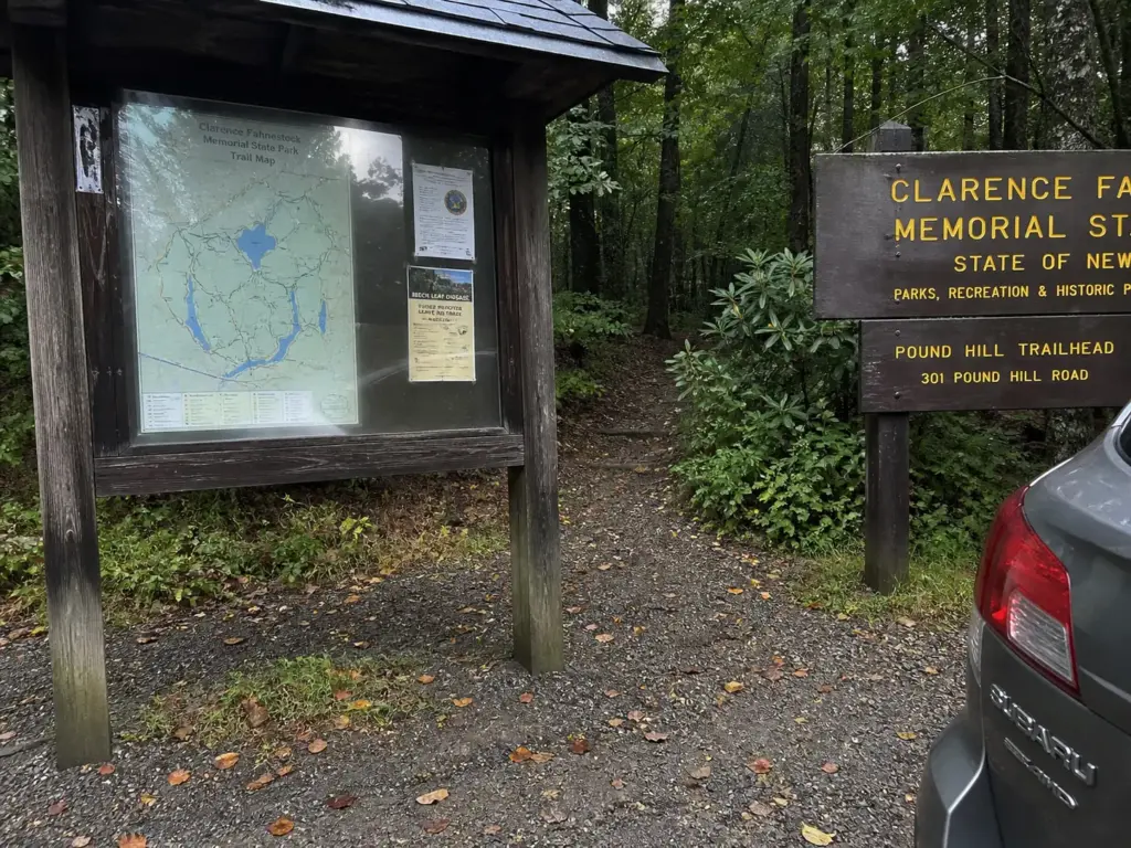 Wooden park sign and trail kiosk at the Route 301 entrance to Fahnestock State Park