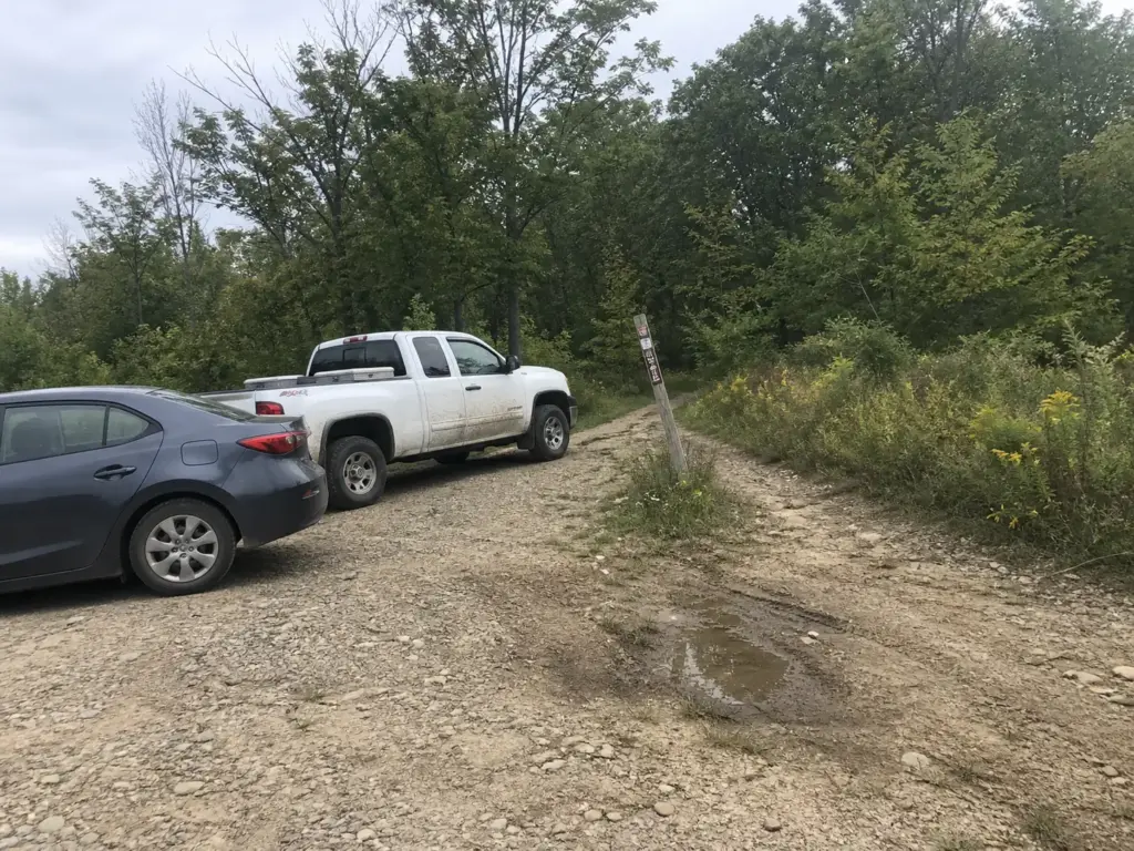 Nearly empty trailhead parking pull-off at Fahnestock State Park on a Sunday afternoon