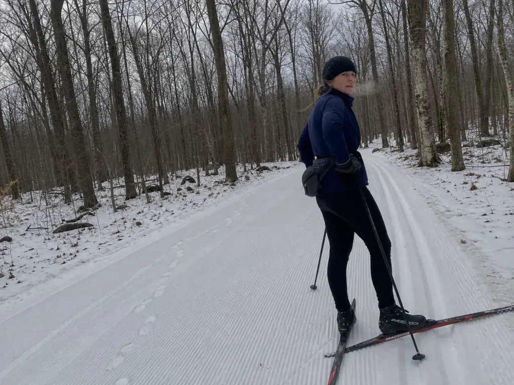 Groomed cross-country ski track through winter woods at Fahnestock Winter Park in New York
