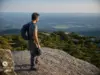 Sam’s Point Hiking Guide — Trails, Caves, Parking Hiker at the Sam's Point overlook in Minnewaska State Park Preserve above the dwarf pine ridge