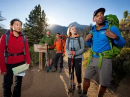 Hikers preparing at a mountain trailhead, showcasing readiness for a day hike with essential gear.