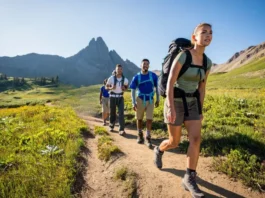 Diverse hikers demonstrating effective pacing on a scenic mountain trail, embodying sustained endurance and energy management for longer hikes.