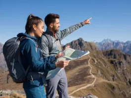 Two diverse hikers, one male and one female, at a mountain overlook, demonstrating ultralight backpacking skills with lightweight gear in a clear, sunny landscape.