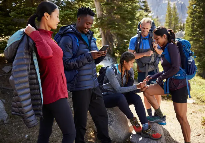 Hikers adapting their gear for different seasons and terrains, showcasing thoughtful preparation for varied hiking conditions.
