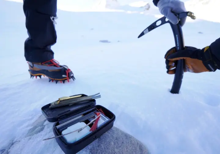 A visual representation of essential winter hiking skills including crampon footwork, ice axe safety, and a field repair kit for maintenance.