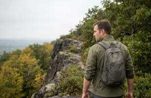 Hiking Places in Connecticut Sorted by Your Day Hiker on the traprock ridge trail at Talcott Mountain, one of the best hiking places in Connecticut.