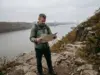 Palisades Interstate Park Trails Build Your Own Loop Hiker checking a trail map on the Long Path above the Hudson in Palisades Interstate Park