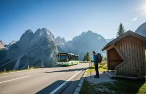 The Definitive Guide: Hiking Europe’s Parks Car-Free A prepared hiker with a backpack waits at a bus stop on a scenic mountain road in the European Alps, as a local bus arrives to begin a car-free day of hiking.