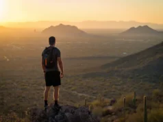 Phoenix Hiking, Decoded: A Guide to the Best Places A dedicated hiker overlooks the best hiking places in Phoenix, with Camelback Mountain visible at sunset.