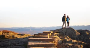 The Ultimate Stairway to Heaven Hike (New Jersey) A couple enjoying the panoramic view from Pinwheel's Vista after completing the Stairway to Heaven hike in New Jersey.