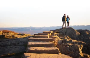 The Ultimate Stairway to Heaven Hike (New Jersey) A couple enjoying the panoramic view from Pinwheel's Vista after completing the Stairway to Heaven hike in New Jersey.