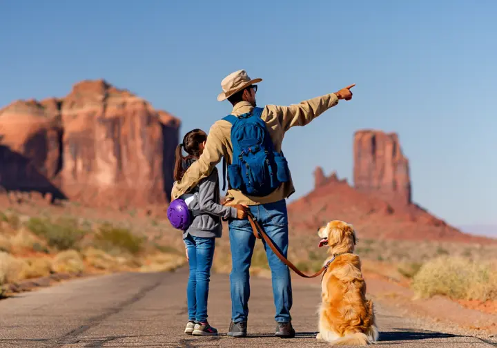 A family with a child and a dog enjoying a curated, dog-friendly hike in Papago Park, Phoenix.