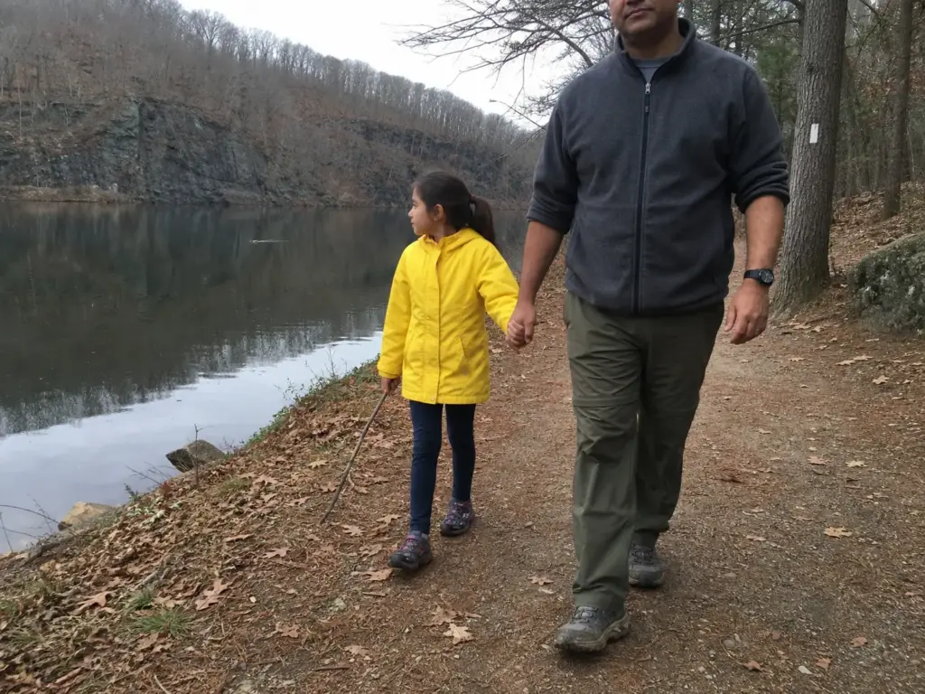 Family walking the flat white-blazed Crescent Lake loop trail at Giuffrida Park