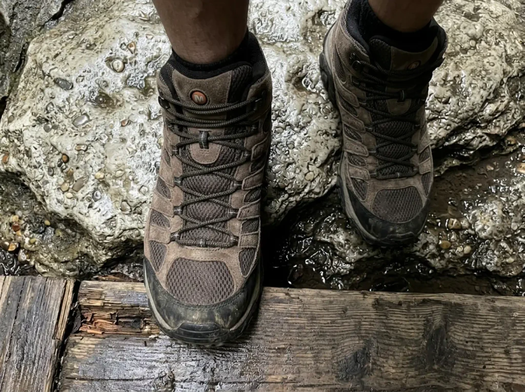 Merrell Moab 3 Mid Waterproof boots on wet boardwalk and rock inside the Sam's Point Ice Cave loop