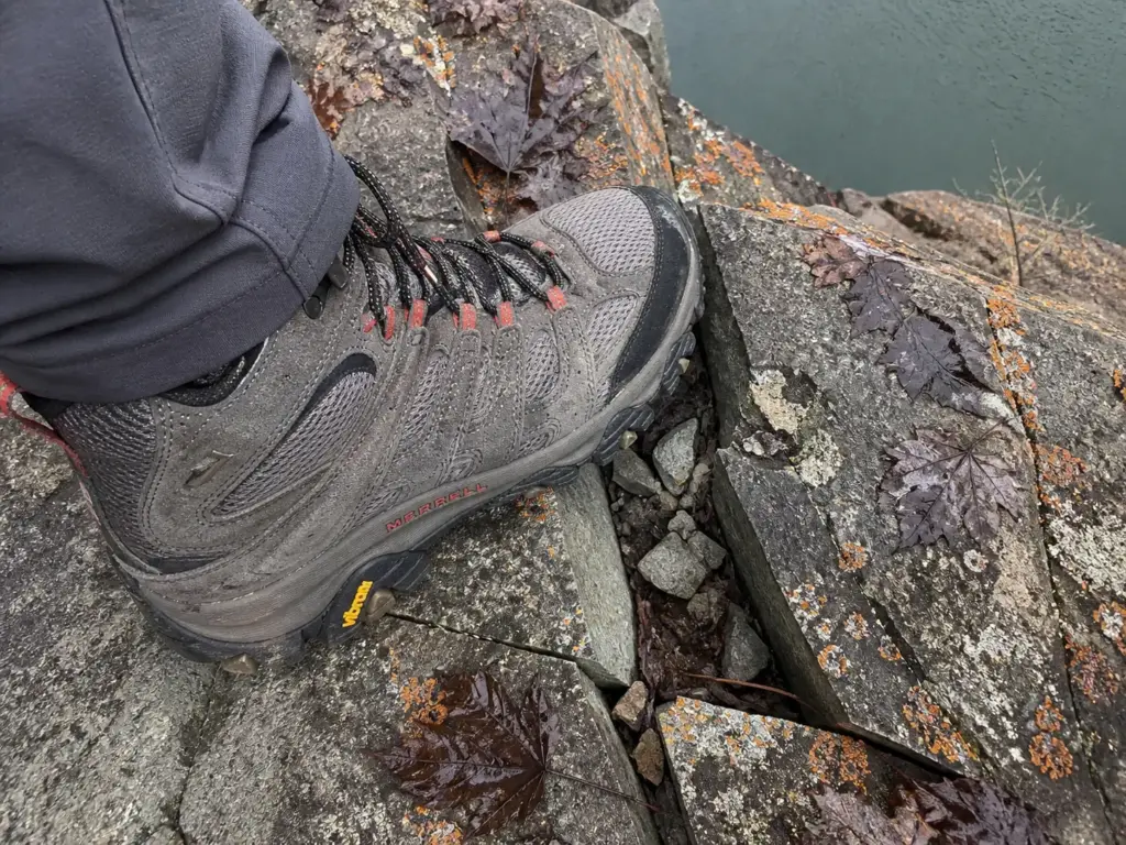 Hiking boot placed on loose fractured traprock on the Chauncey Peak ridge in Connecticut