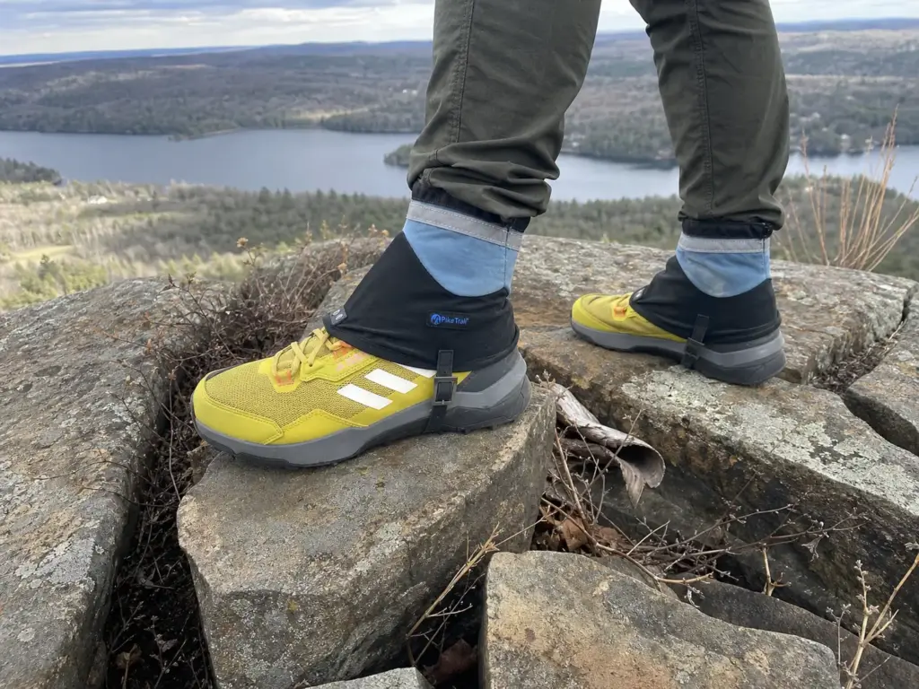 Ankle gaiters on a hiker stepping across rocky ledge habitat on a Connecticut traprock ridge