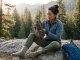 How to Read Hiking Boot Anatomy Before You Buy Hiker examining hiking boot anatomy before a trail — midsole and outsole visible