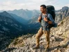Framed vs Frameless Backpack The 25-lb Rule Backpacker carrying a loaded framed backpacking pack up an alpine pass at golden hour