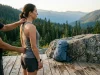 How to Measure Your Torso Length for a Backpack Hiker measuring torso length with a flexible tape down the spine to size a backpack
