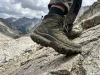 What Is a Boot Shank? The Part Most Hikers Get Wrong Close-up of hiker's boot sole pressing into rocky trail showing boot construction layers and shank support