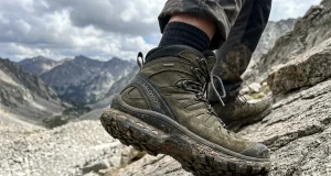 What Is a Boot Shank? The Part Most Hikers Get Wrong Close-up of hiker's boot sole pressing into rocky trail showing boot construction layers and shank support