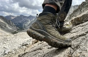 What Is a Boot Shank? The Part Most Hikers Get Wrong Close-up of hiker's boot sole pressing into rocky trail showing boot construction layers and shank support