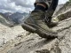 What Is a Boot Shank? The Part Most Hikers Get Wrong Close-up of hiker's boot sole pressing into rocky trail showing boot construction layers and shank support