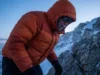 Responsible Down Standard: A Hiker’s Guide to Ethical Gear A mountaineer braving high winds on a snowy ridge wearing a thick RDS-certified down parka.