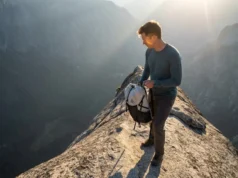 Yosemite Decimal System: A Hiker’s Guide to Risk A hiker stands on a high, exposed rocky ridge looking down into a deep valley, illustrating the risks of the Yosemite Decimal System.