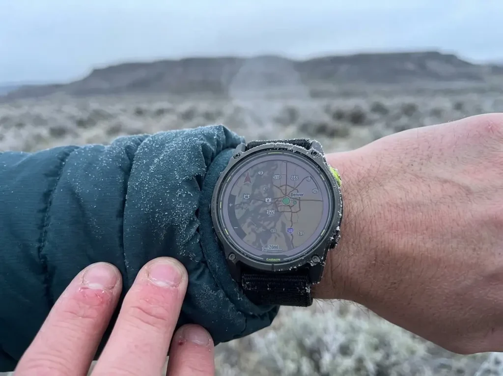 Garmin Enduro 3 GPS watch on a frost-dusted jacket cuff on a cold morning hike