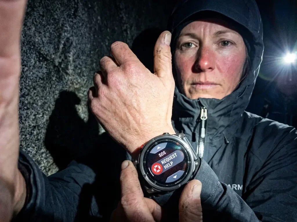 Garmin fenix 8 Pro GPS watch lit by flash in the pre-dawn dark on a backcountry alpine start
