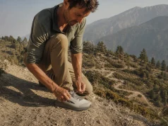 Hiking Shoe Toe Bumper Protection What to Feel For Hiker re-tensioning laces on Altra Lone Peak 9 shoes at the top of a steep descent