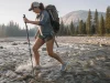Why Drainage Holes Beat Waterproof Boots at Wet Crossings Hiker mid-creek in low-cut drainage shoes crossing a Sierra Nevada snowmelt stream on the Pacific Crest Trail