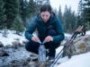 Chemical Treatment Times in Cold Water: The Real Numbers Hiker adding Aquamira chemical treatment drops to cold mountain stream water in winter conditions