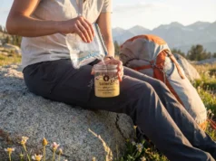 No Cook Backpacking Meals: What Works (And What Doesn’t) Hiker cold soaking no-cook backpacking meal in Talenti jar on alpine trail during golden hour