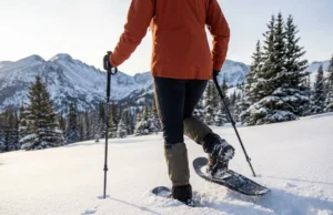 Gaiters for Deep Powder? What Works (And What Doesn’t) Snowshoer breaking trail through deep powder showing knee-high gaiters protecting against snow entry