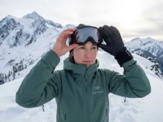 Stop Goggle Fogging on Winter Hikes: 7 Field-Tested Fixes Winter hiker examining fogged Smith goggles on snowy alpine ridge above treeline