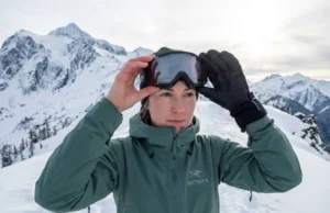 Stop Goggle Fogging on Winter Hikes: 7 Field-Tested Fixes Winter hiker examining fogged Smith goggles on snowy alpine ridge above treeline