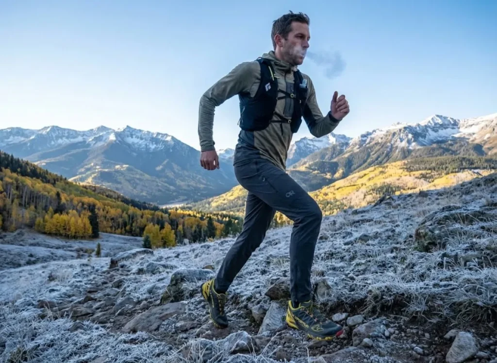 Trail runner moving efficiently on cold morning trail during shoulder season in Colorado
