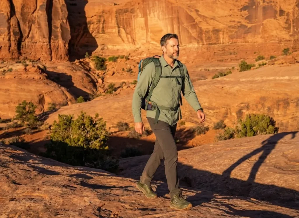 Hiker exploring Moab desert terrain during comfortable November shoulder season