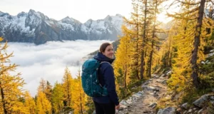 Shoulder Season Hiking: Why Smart Hikers Skip Peak Season Hiker on empty fall trail above cloud inversion during shoulder season in North Cascades
