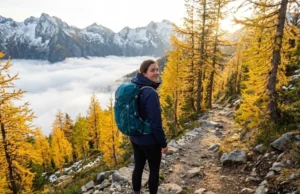 Shoulder Season Hiking: Why Smart Hikers Skip Peak Season Hiker on empty fall trail above cloud inversion during shoulder season in North Cascades