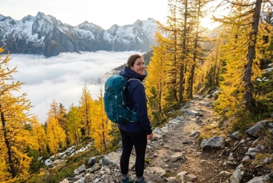 Shoulder Season Hiking: Why Smart Hikers Skip Peak Season Hiker on empty fall trail above cloud inversion during shoulder season in North Cascades