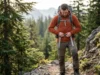 How to Adjust Sternum Strap Height for Better Breathing Hiker adjusting sternum strap height on Osprey backpack on mountain trail