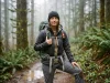 Is Your Sternum Strap Whistle Loud Enough? Hiker on a forest trail wearing a backpack, sternum strap whistle buckle visible at chest level