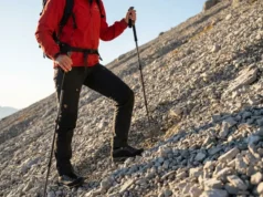 Tape Ankles to Prevent Sprains on Unstable Ground A professional hiker navigating technical scree terrain in the Dolomites wearing Arc'teryx and La Sportiva gear, demonstrating stability and confidence.