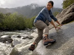 Which Outsole Rubber Grips Wet Rock? Not the Logo Hiker testing outsole rubber grip on wet rock with a Vibram Megagrip hiking boot after rain