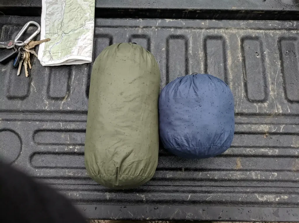 Two rain jackets stuffed to different sizes side by side, showing packable is not the same as ultralight